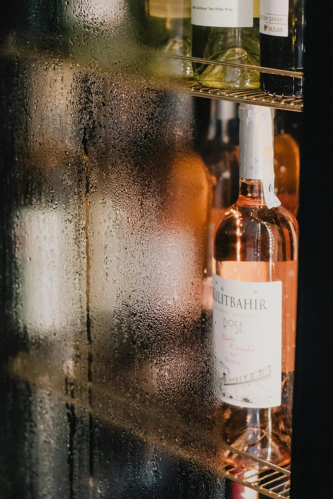 Wine fridge with bottles stored horizontally at the correct cellar temperature